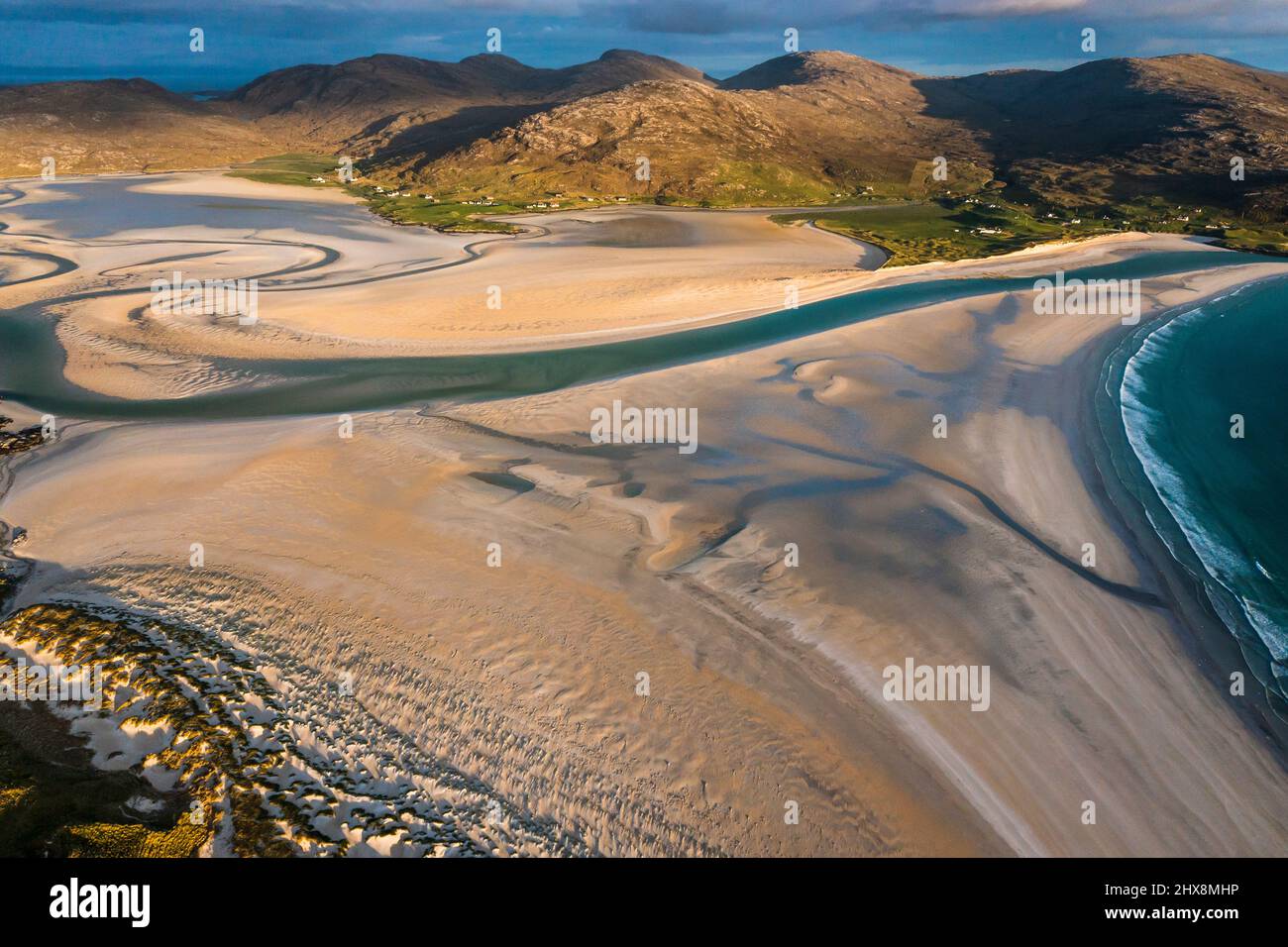 Not a soul in sight as aquamarine waters lap against this perfect white beach. Stock Photo