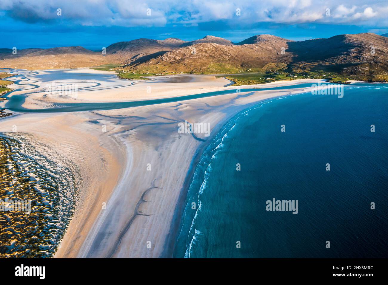 Not a soul in sight as aquamarine waters lap against this perfect white beach. Stock Photo