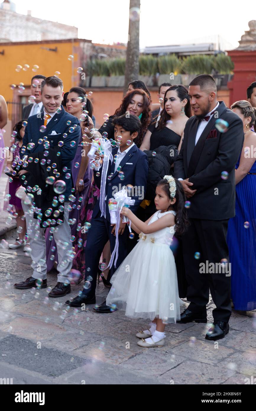 Mexico, Guanajuato, San Miguel de Allende,   young girl at wedding blowing bubbles with a bubble gun Stock Photo