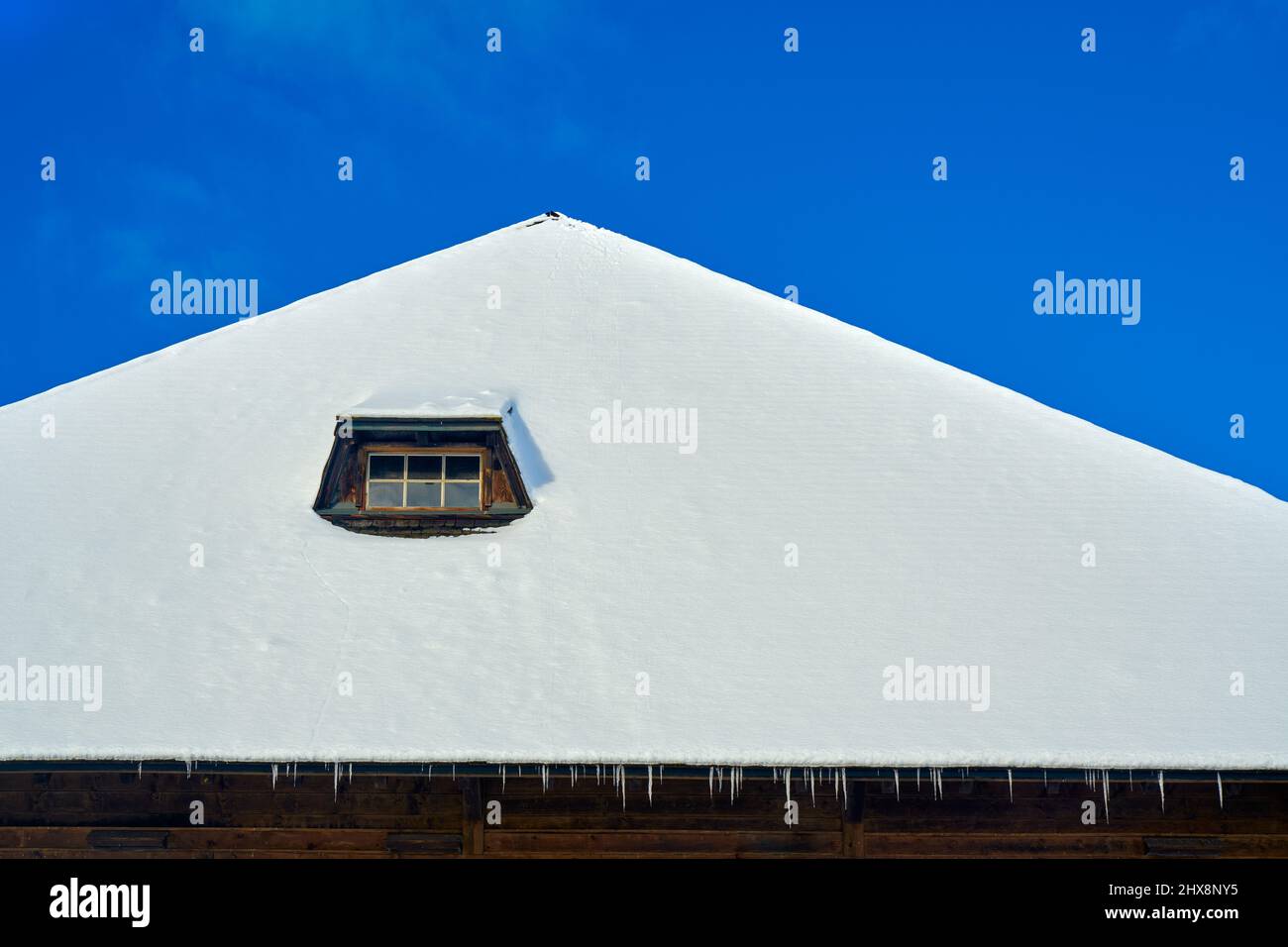 A window in a snow-covered roof Stock Photo - Alamy