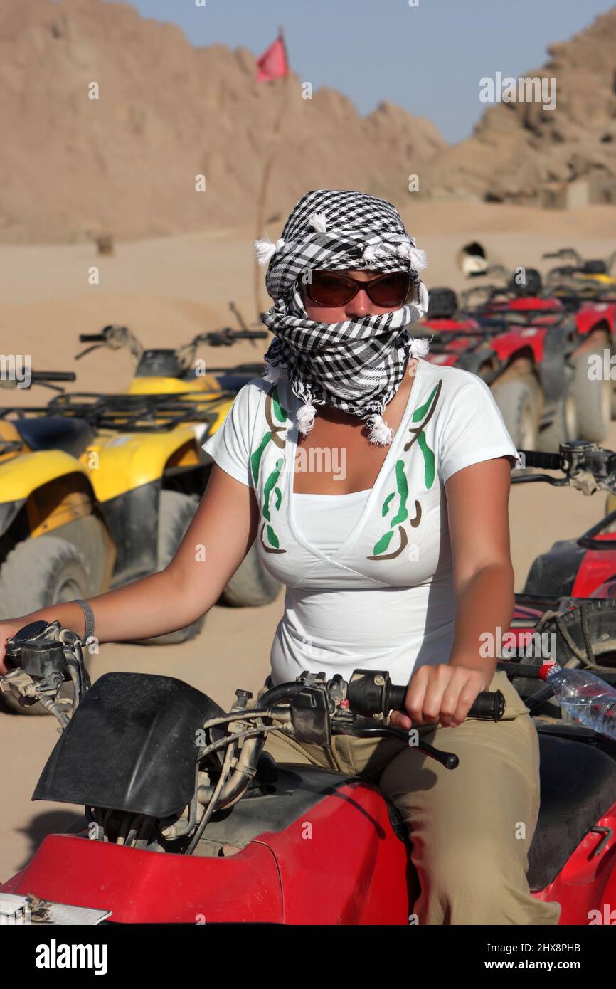 The girl poses on a quad bike, Egypt Stock Photo Alamy