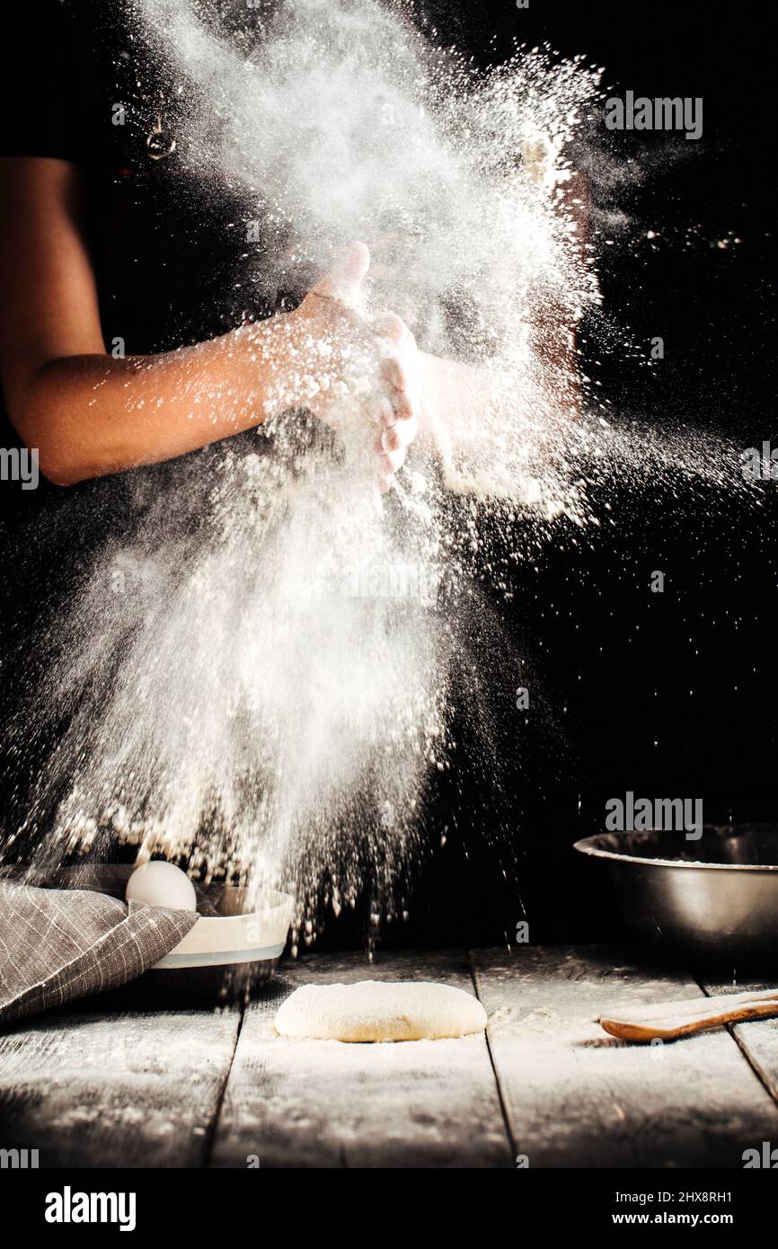 Baker hand with flour pizza preparation Stock Photo Alamy