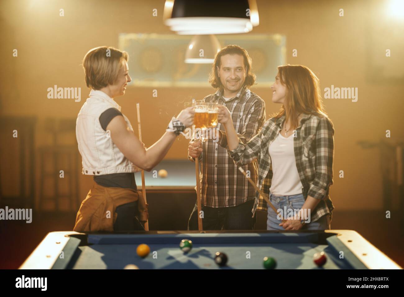 Billiards game. young friends playing pool together Stock Photo - Alamy