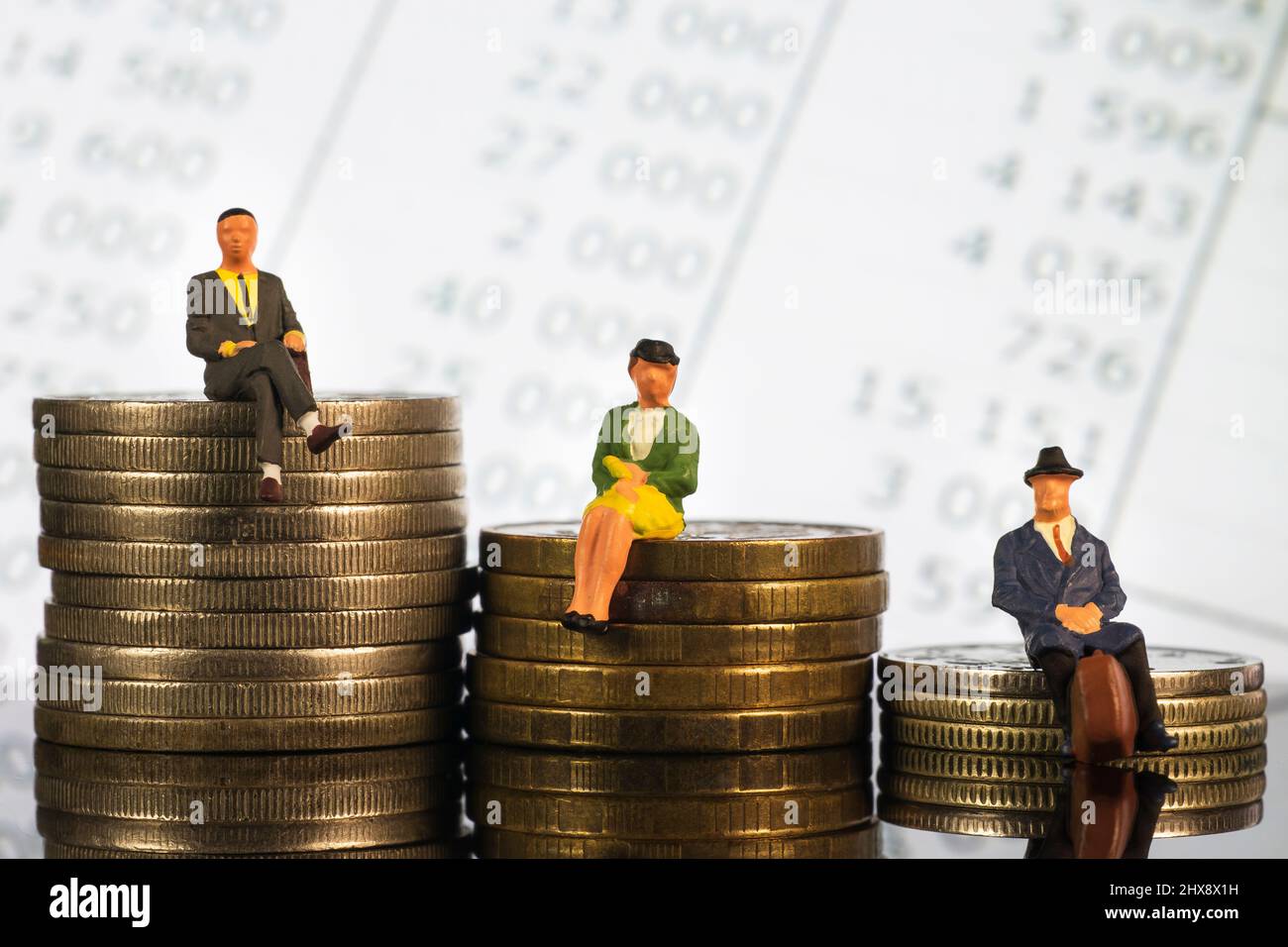 Miniature people: Elderly people sitting on coins stack. Retirement planning. money saving and investment. Time counting down for retirement and pensi Stock Photo