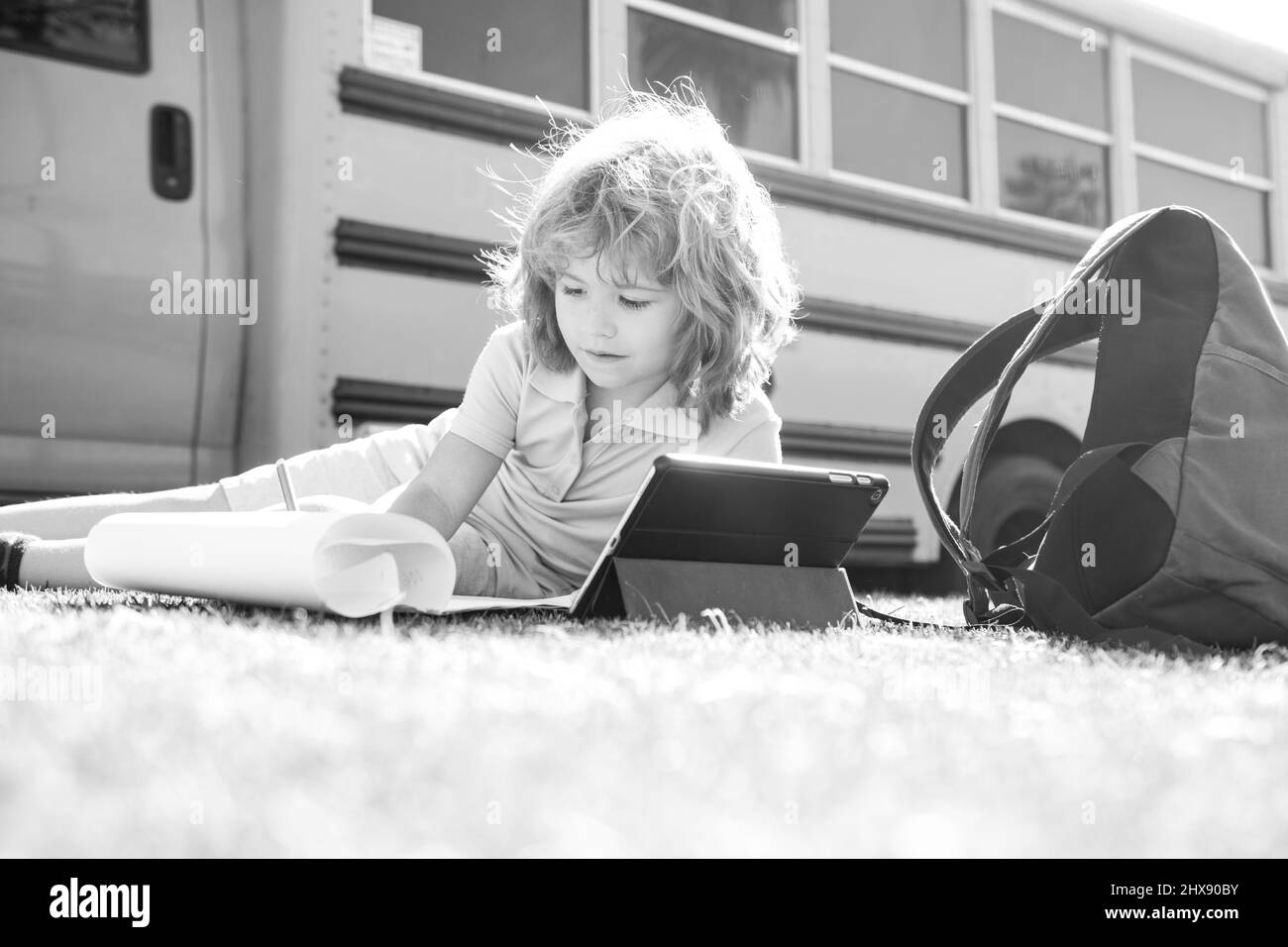 Back to school. Happy child study in park near school bus. Schoolboy ...