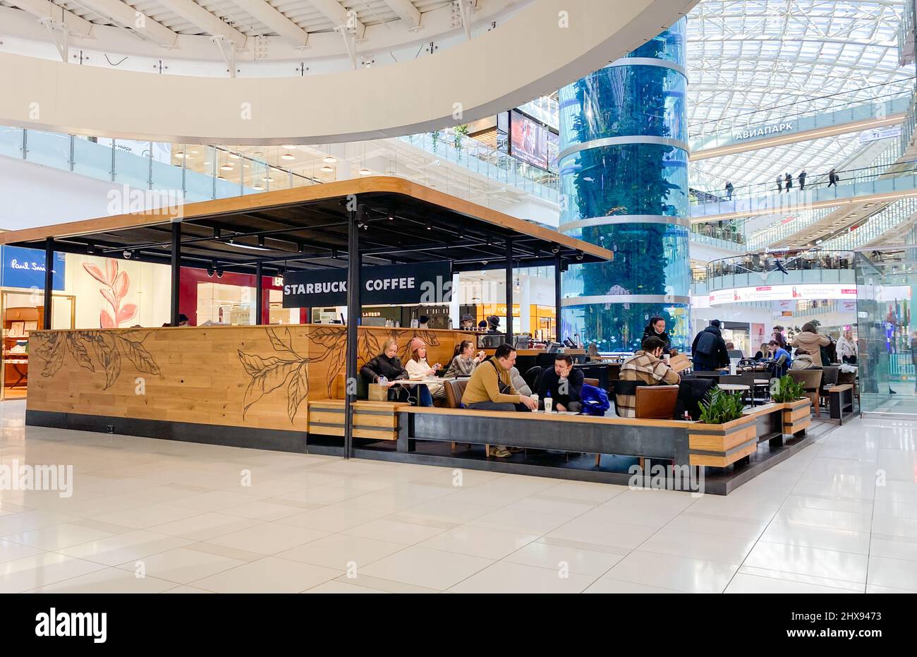 Moscow, Russia, March 2022: Starbuck Coffee in a shopping mall. People are sitting, speaking, drinking coffee, surfing the web, eating. Stock Photo