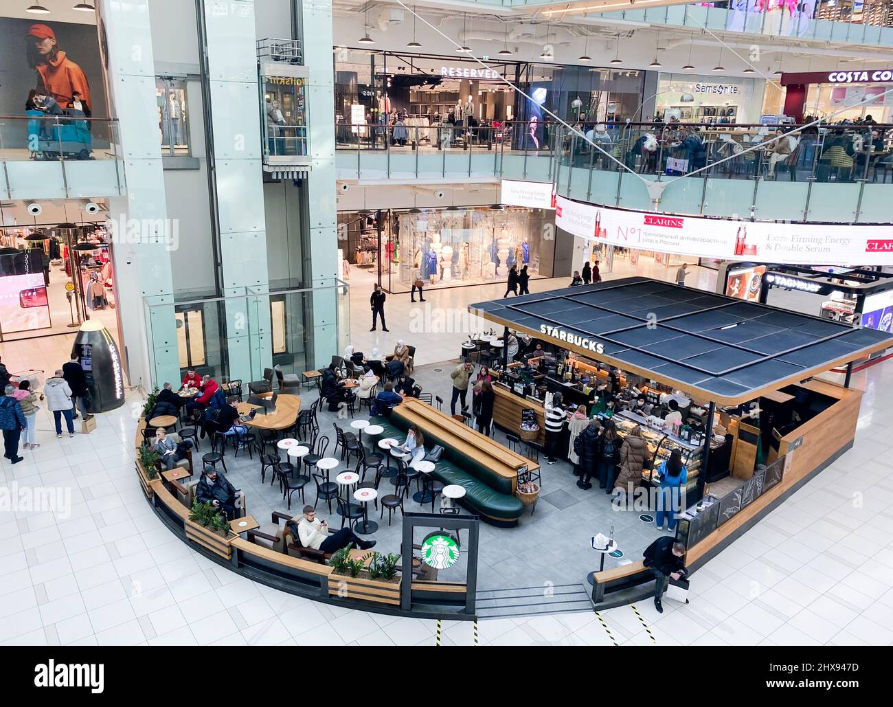 Moscow, Russia, March 2022: Top view Starbuck Coffee in a shopping mall. People are sitting, speaking, drinking coffee, surfing the web, eating. Stock Photo