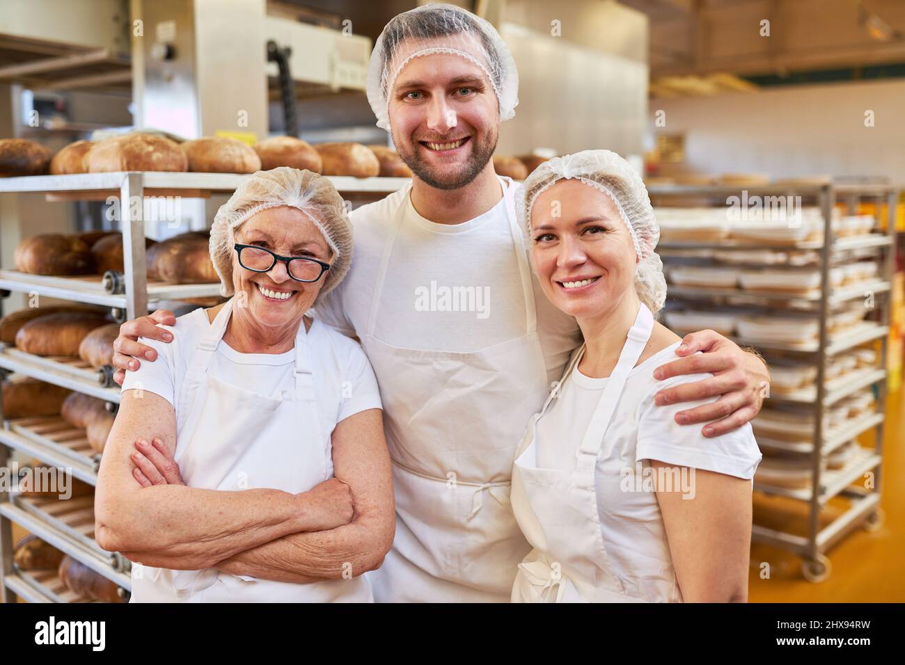 Successful bakery team with boss and apprentices in the bakery as a family business Stock Photo