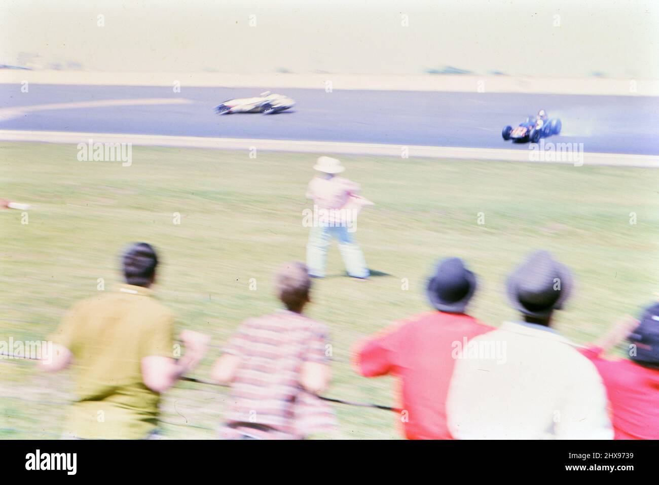 Watching the 1963 Indianapolis 500 race from the race track infield ca. 1963 Stock Photo