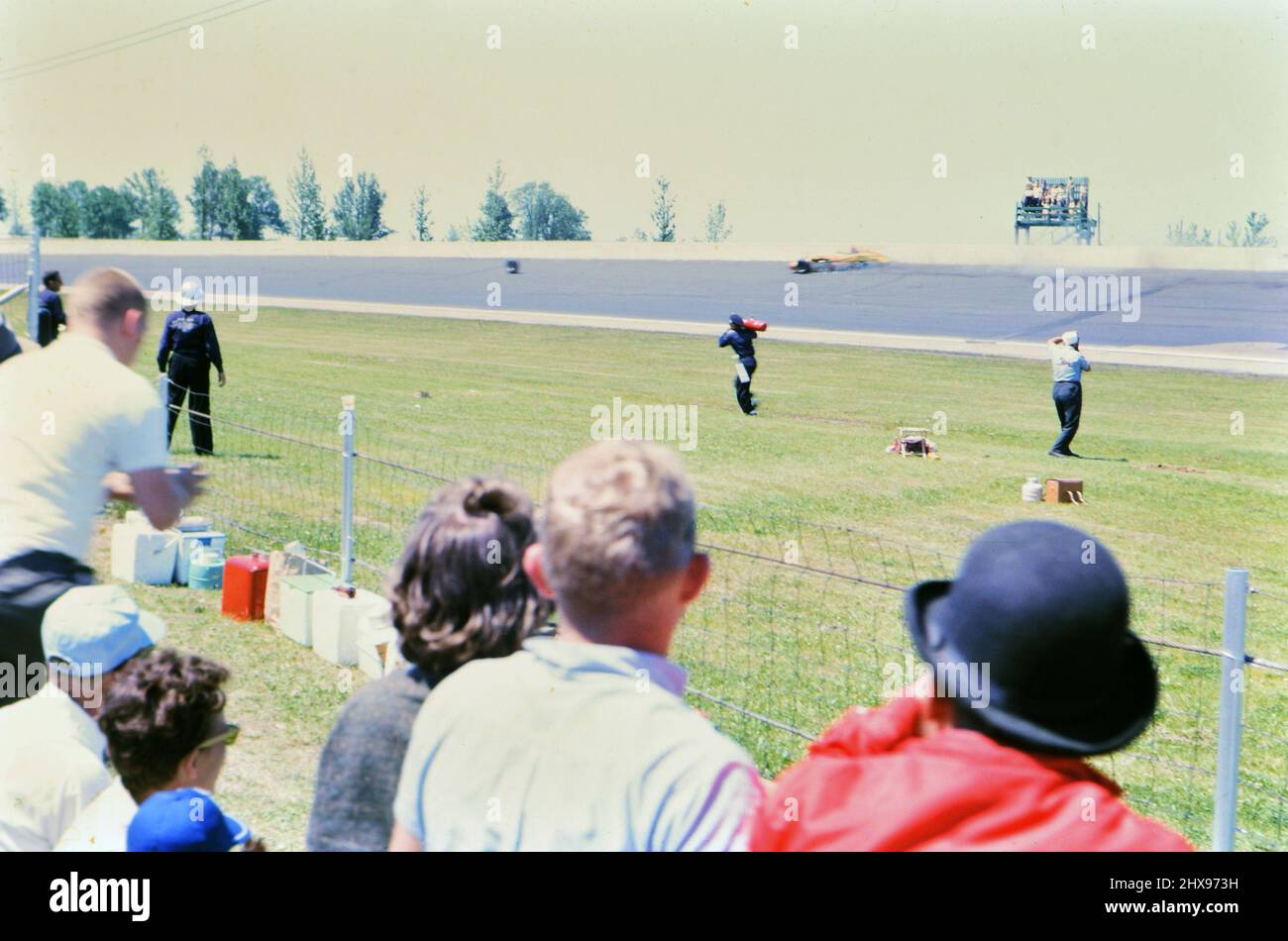 The 1963 Indianapolis 500 race from the race track infield, rescue crew going to attened to a wrecked car on the track ca. 1963 Stock Photo