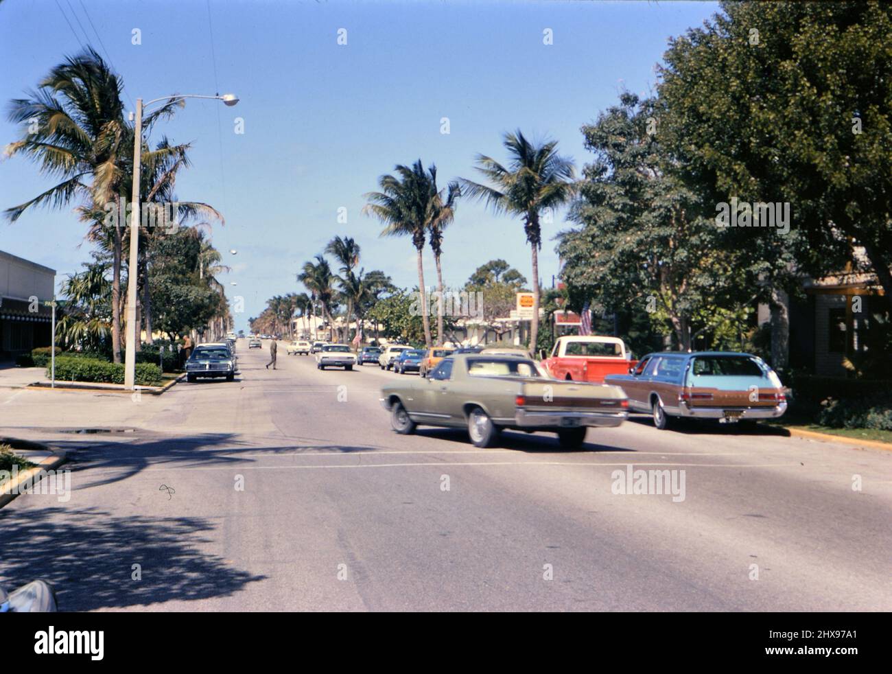 Car making a left hand turn on a street in Naples Florida ca. 1971 Stock Photo