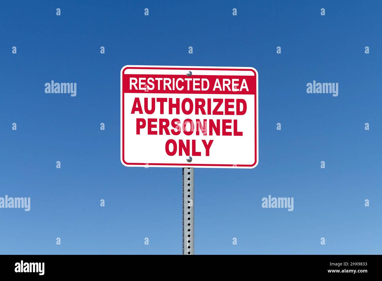 Restricted Area, Authorized Personnel Only, street sign with blue sky background Stock Photo