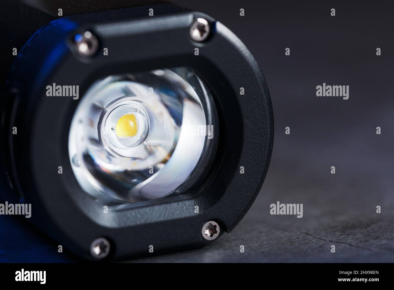 Black Rechargeable Flashlight handheld, LED close-up on a black background Stock Photo