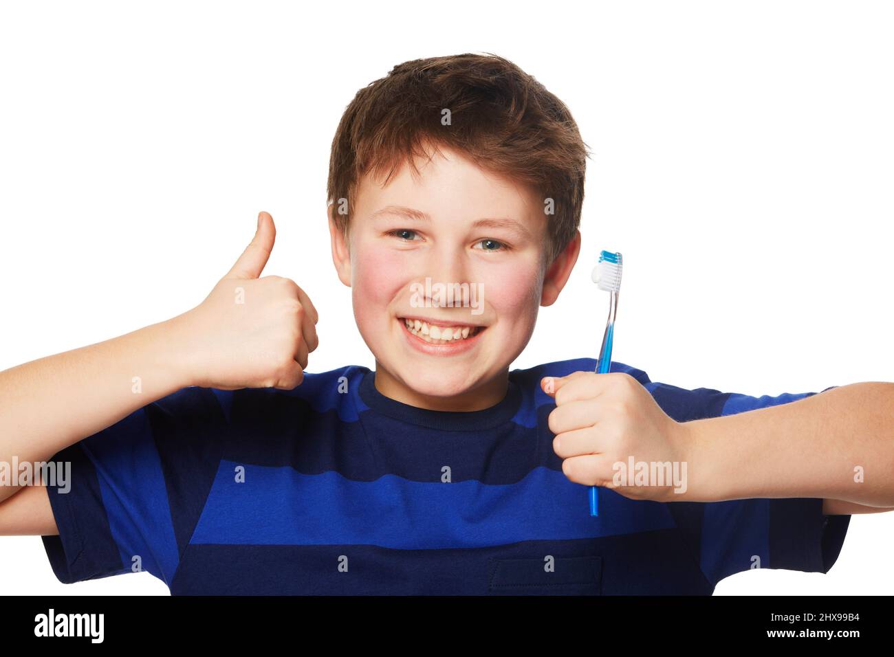 Dental hygiene gets the thumbs up. Portrait of a young boy holding is toothbrush and giving a thumbs up. Stock Photo