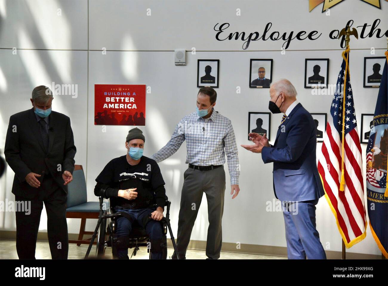 Fort Worth, United States of America. 08 March, 2022. U.S President Joe Biden applauds Army Veteran John Caruso after a display of his ability to walk using an Exoskeleton system assisted by Spinal Cord Injury lead physical therapist Josh Geering, center, at the North Texas Ft. Worth Veterans Clinic, March 8, 2022 in Fort Worth, Texas. Credit: Veterans Affairs/Veterans Affairs/Alamy Live News Stock Photo