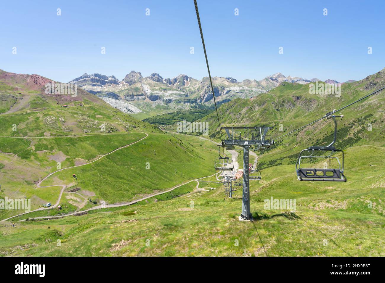 Chair lift of the Astun ski resort in summer and Lakes of Astun hike in Aragon pyrenees mountains in a suuny day Stock Photo