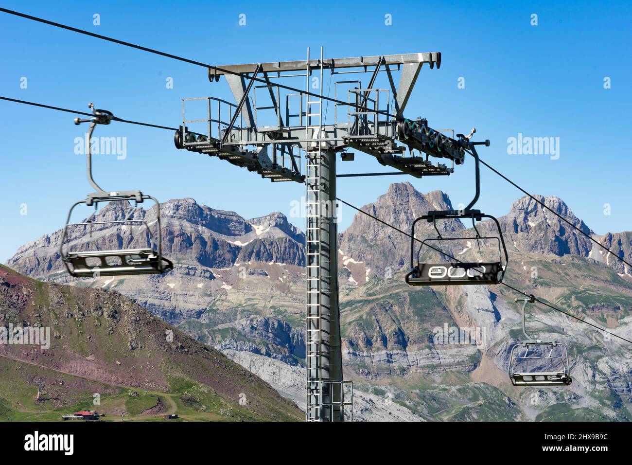 Chair lift of the Astun ski resort in summer and Lakes of Astun hike in Aragon pyrenees mountains in a suuny day Stock Photo