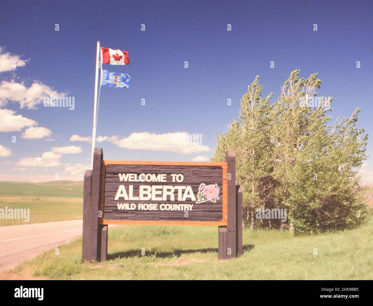 Welcome to Albert Canada sign with Canadian flag flying above ca. 1990 ...