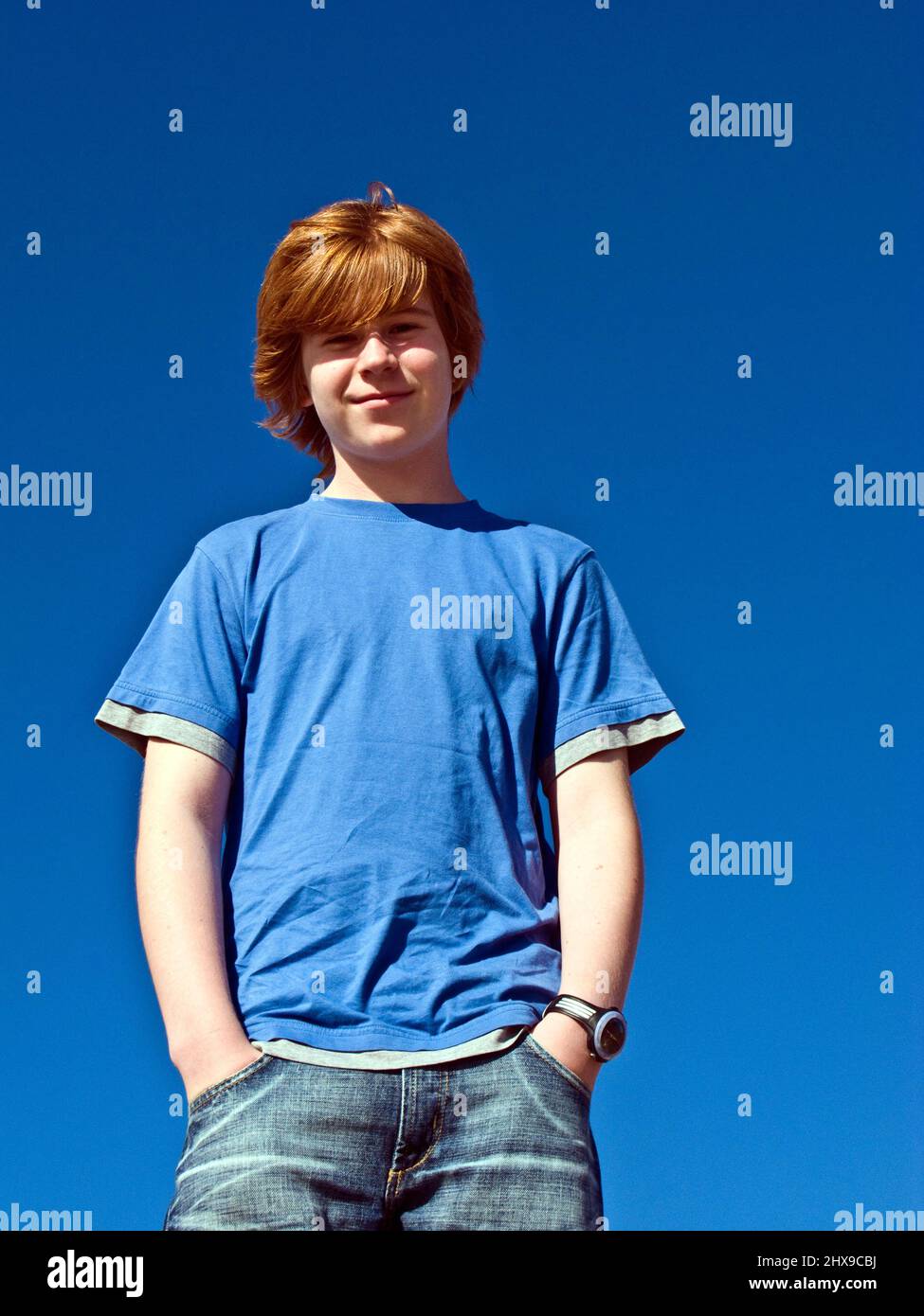 cute young boy smiling under blue sky Stock Photo - Alamy