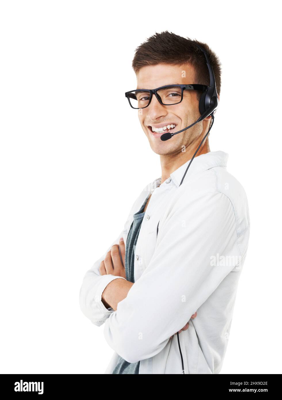 Guess whos on the line. Portrait of a smiling hipster man with a headset on and his arms crossed. Stock Photo