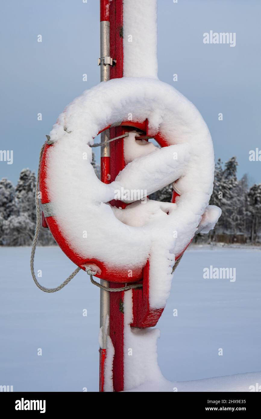 Snow covered lifebuoy after heavy snowfall Stock Photo