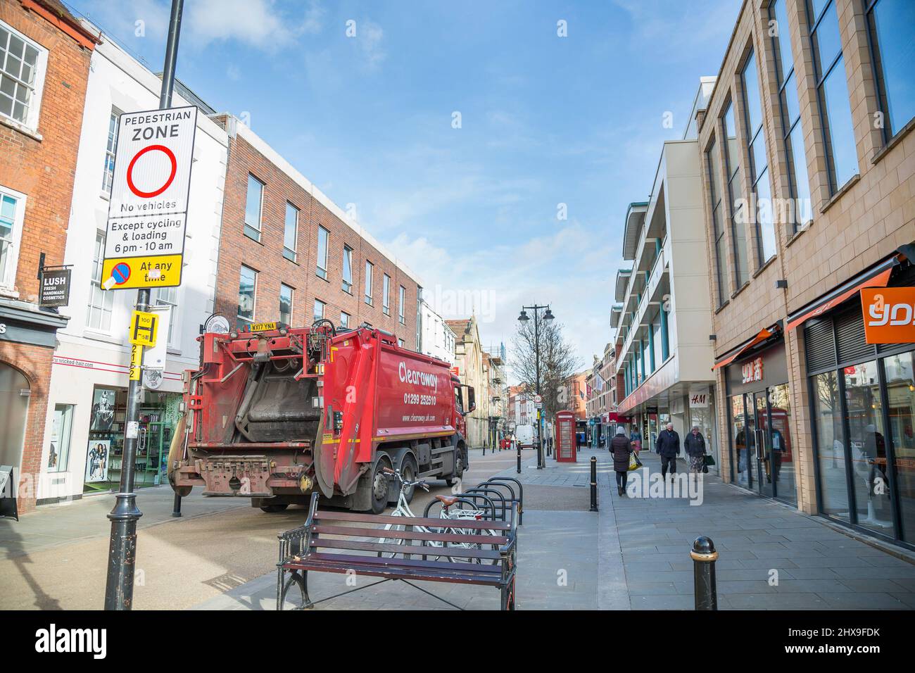 Rear view of a red Clearaway refuse lorry in the High Street, Worcester, UK, collecting