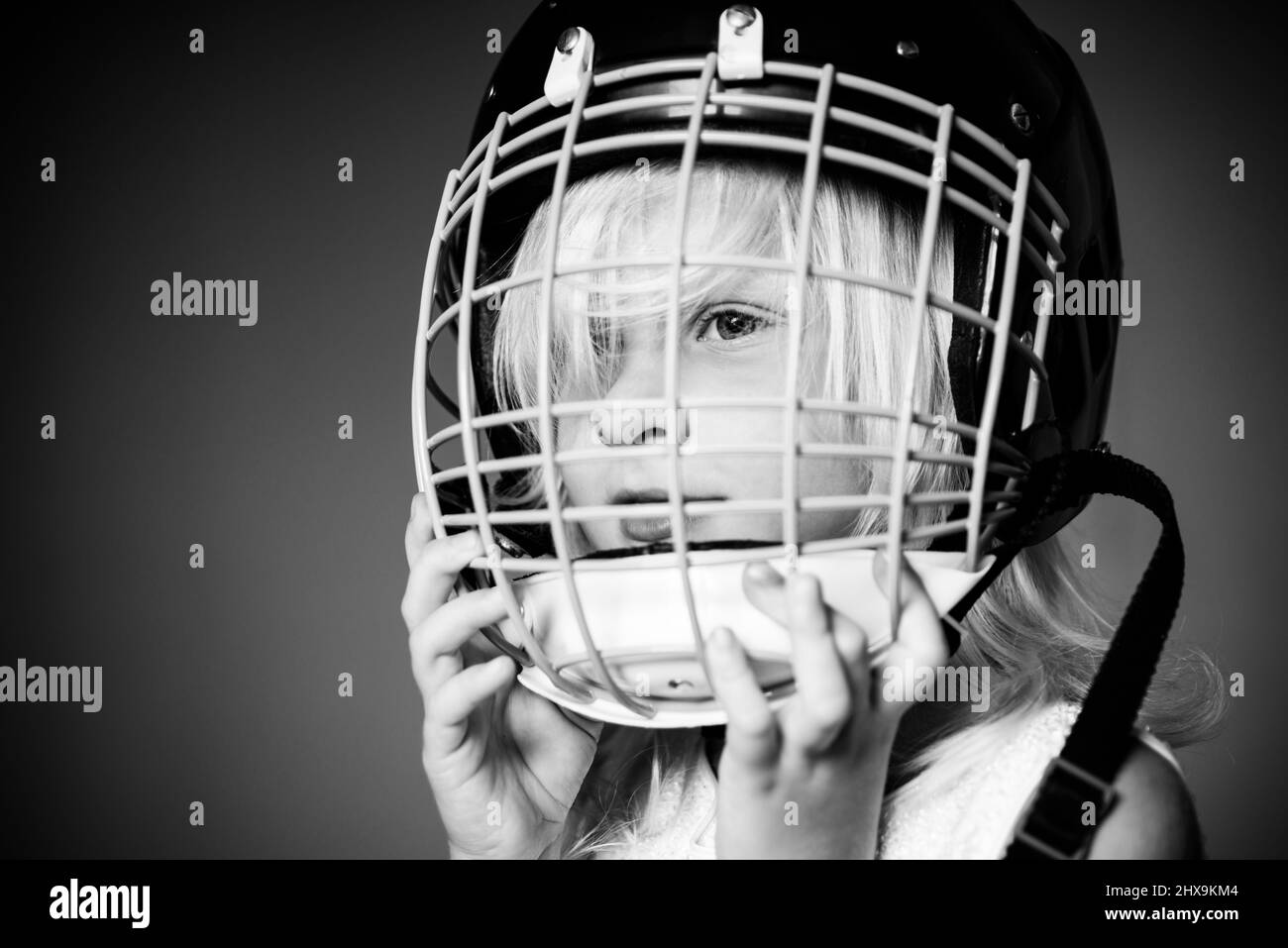 Girl cute child wear hockey helmet close up. Safety and protection