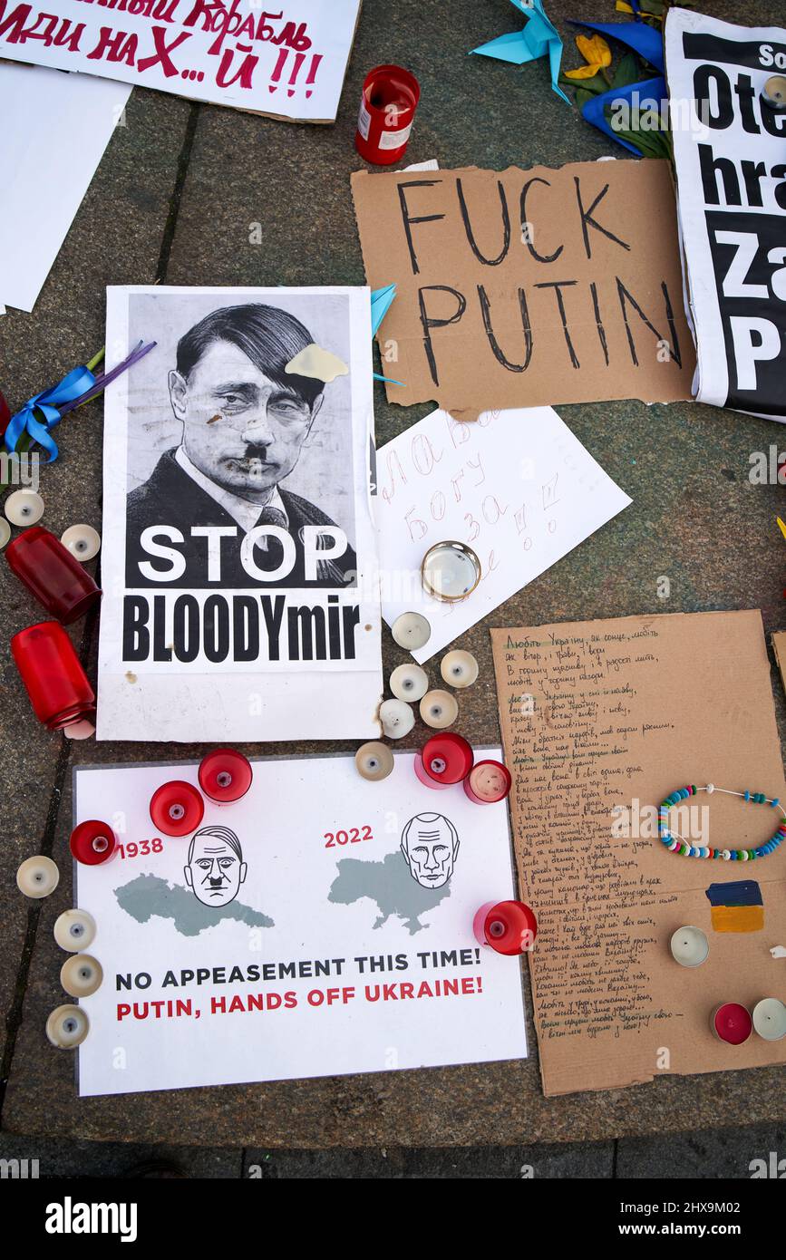 PRAGUE, CZECH REPUBLIC - MARCH 3, 2022: Signs supporting Ukraine and depicting president of Russia Vladimir Putin as Adolf Hitler at Wenceslas Square Stock Photo