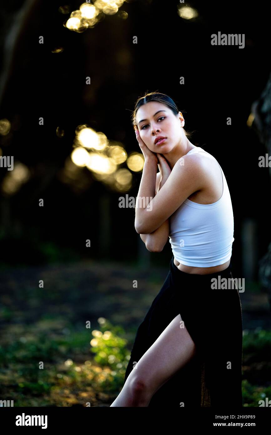 Young Multiracial Female Dancer In Grove of Cypress Trees Stock Photo