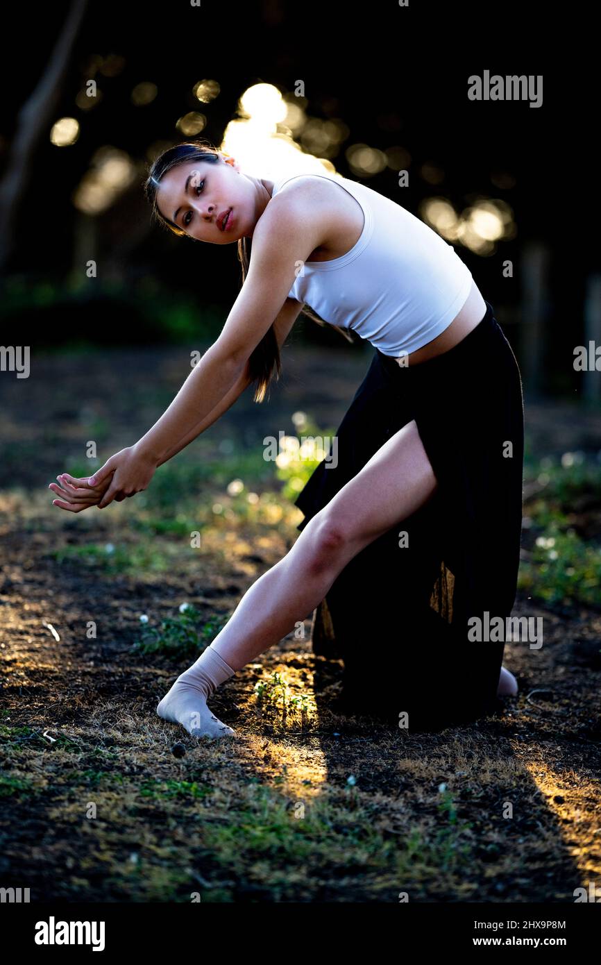 Young Multiracial Female Dancer In Grove of Cypress Trees Stock Photo