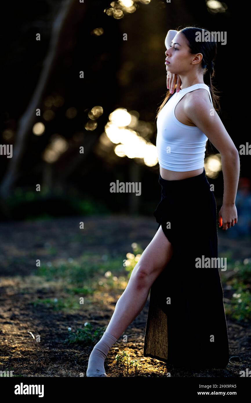 Young Multiracial Female Dancer In Grove of Cypress Trees Stock Photo