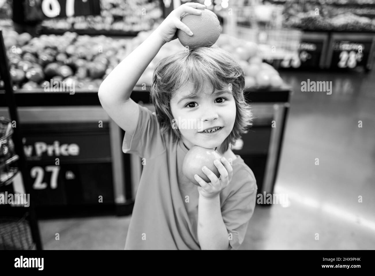 American kid with shopping trolley with in grocery store. Supermarket, Shopping with Child. Stock Photo