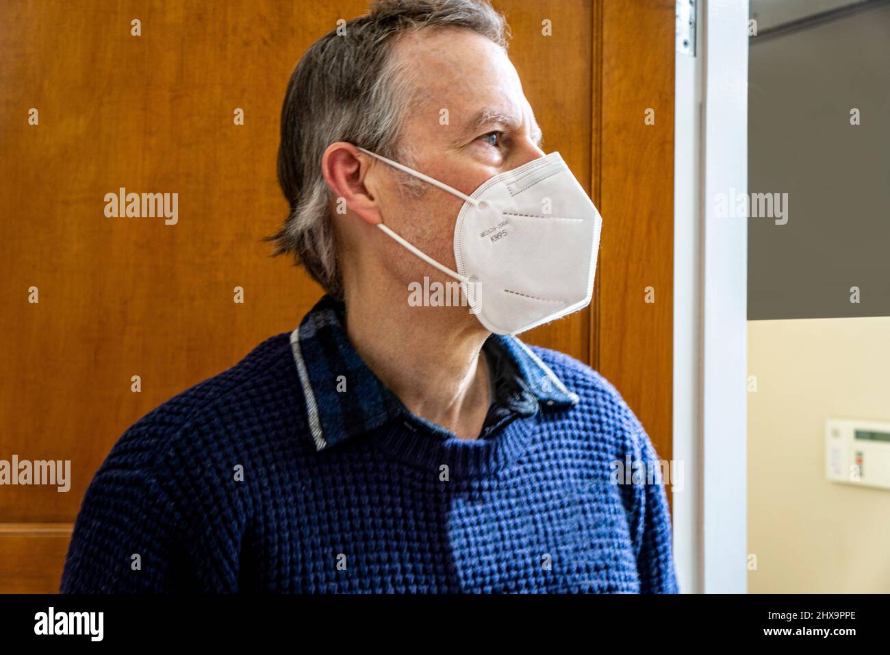 Man wearing Protective Face Mask, head and shoulders Profile Stock Photo