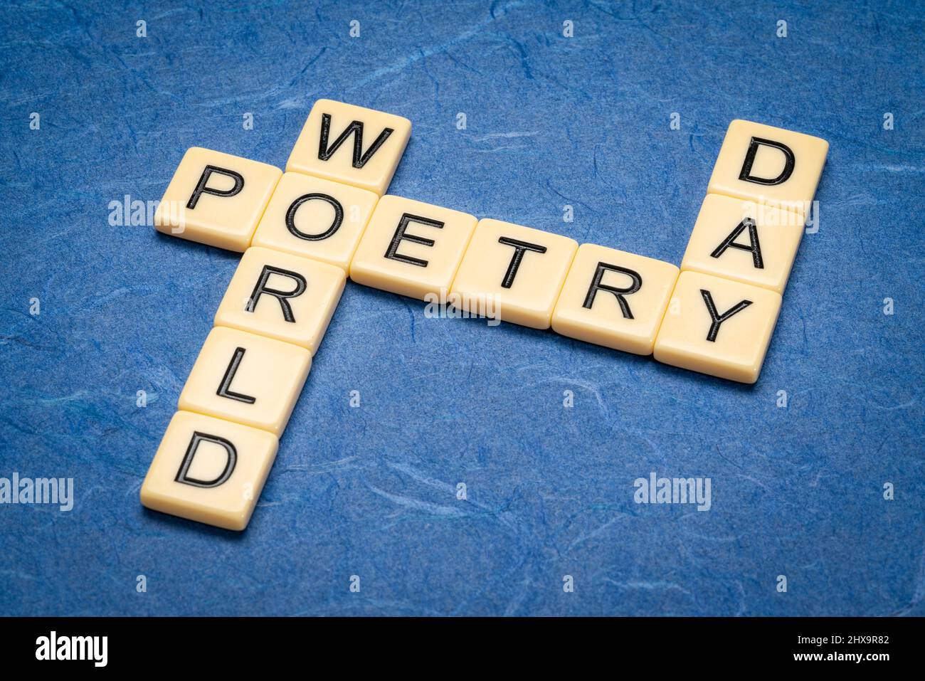 World Poetry Day crossword in ivory letter tiles against textured