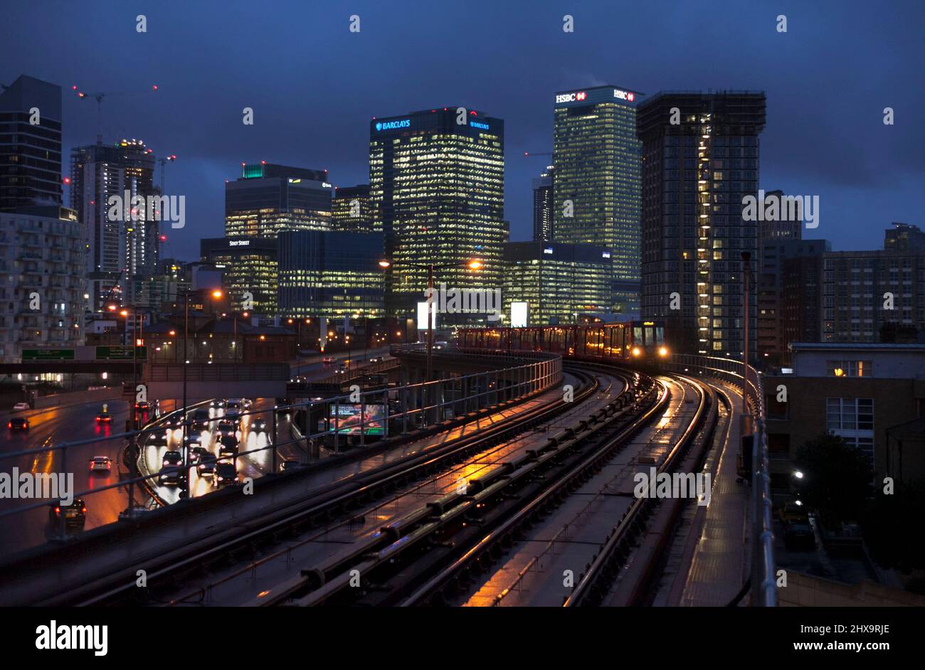 East India Docklands light railway station, DLR train heading away from the city of london Stock Photo