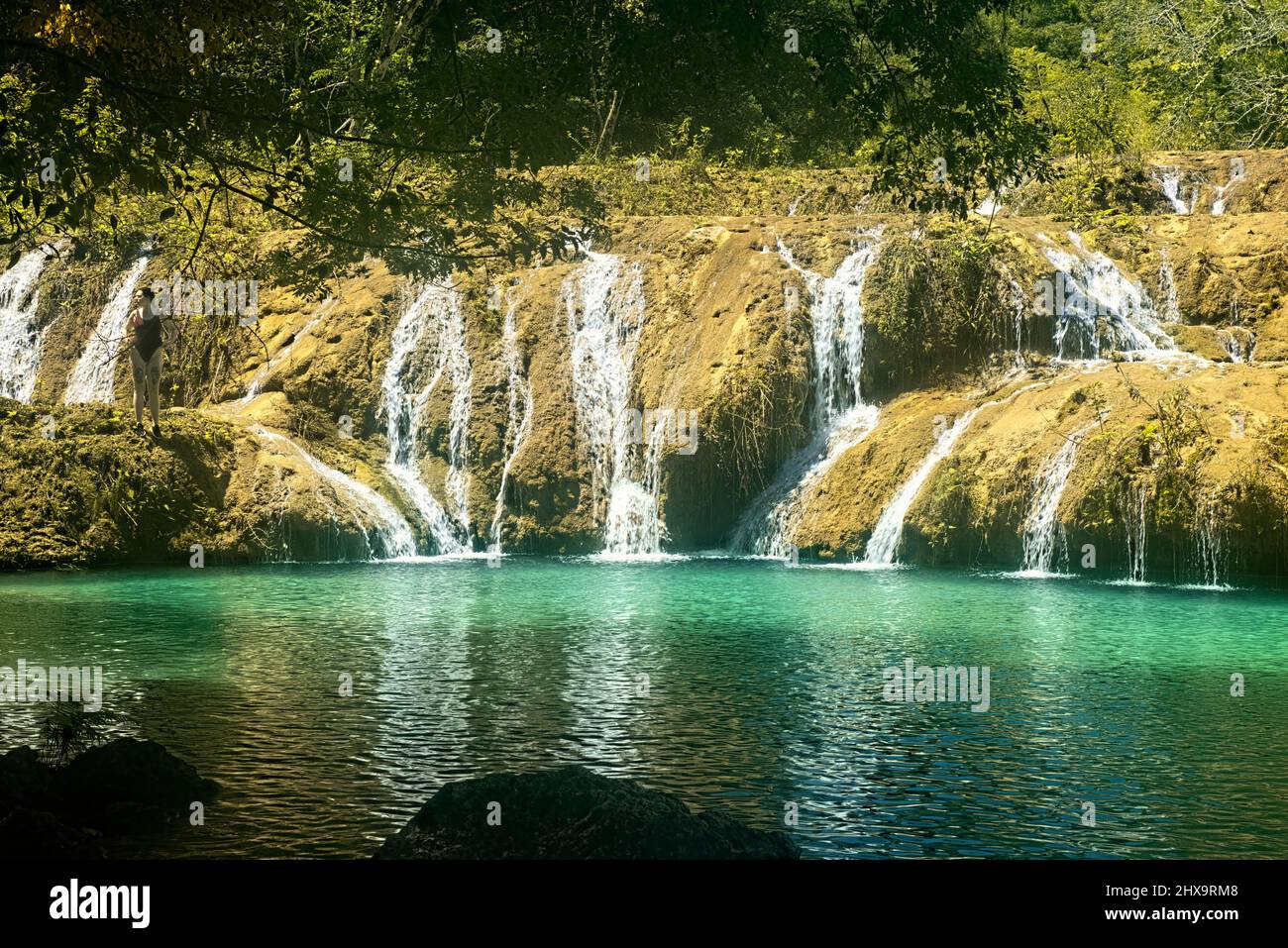 Tourist enjoying the beautiful pools of Semuc Champey, Rio Cabohon, Lanquin, Alta Verapaz, Guatemala Stock Photo