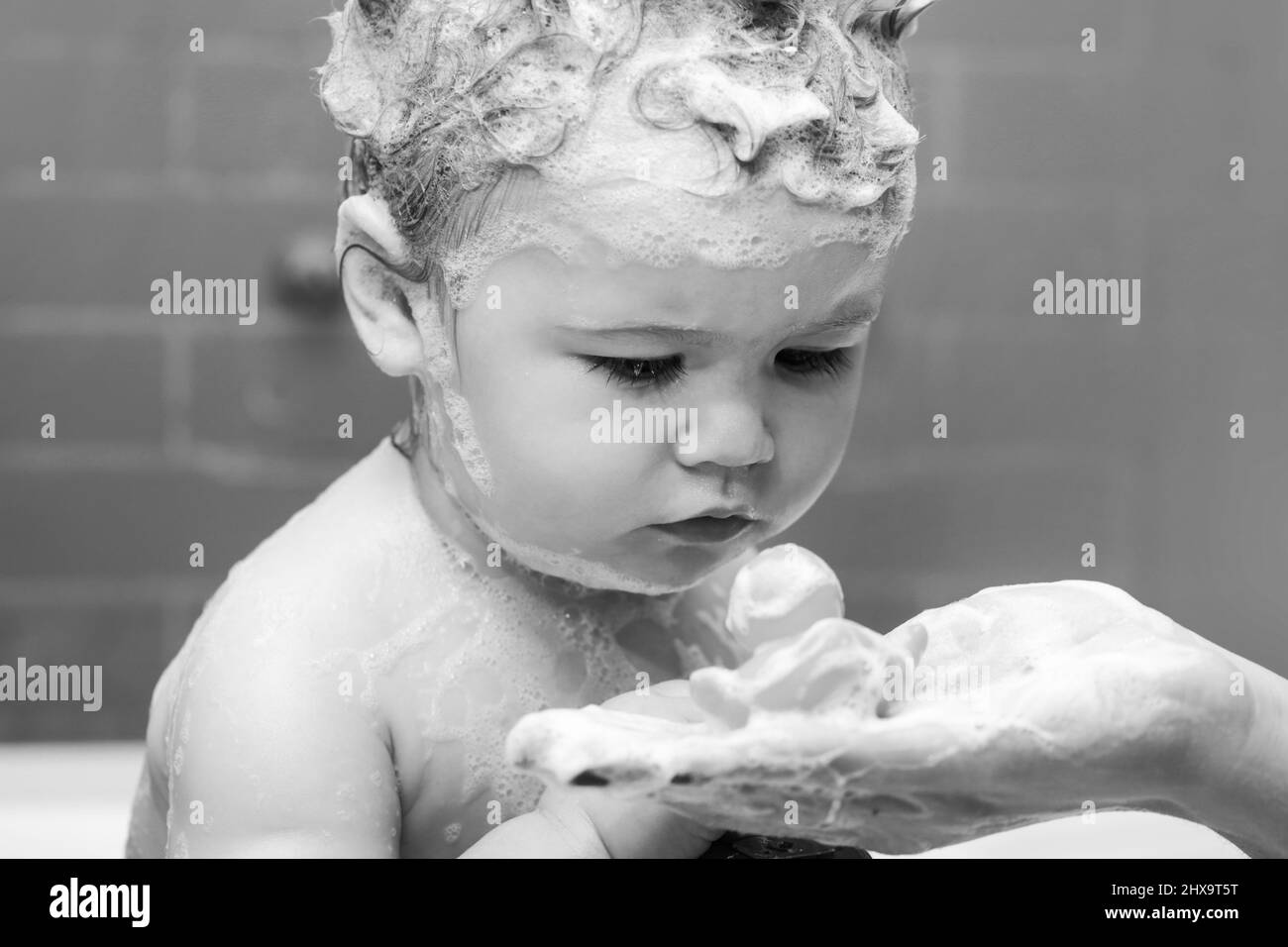 Hygiene and body care for children. Baby child washing in a bathroom in ...