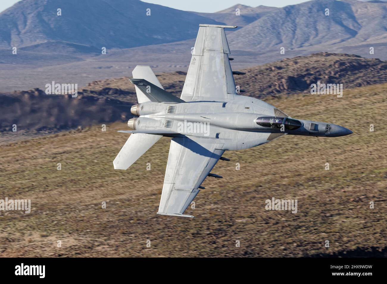 Boeing F/A-18E Hornet flown by US Navy squadron VFA-25 'Fist of the Fleet' from NAS Lemore Flying through Death Valley during 2019 Stock Photo