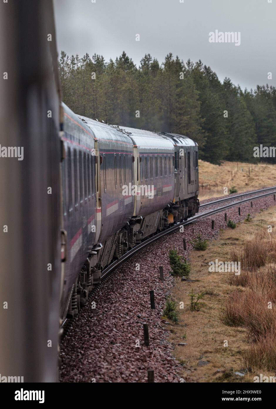 View from the London Euston to Fort William Caledonian sleeper train as it approaches Rannoch on the west highland line in Scotland, hauled by 73969 Stock Photo