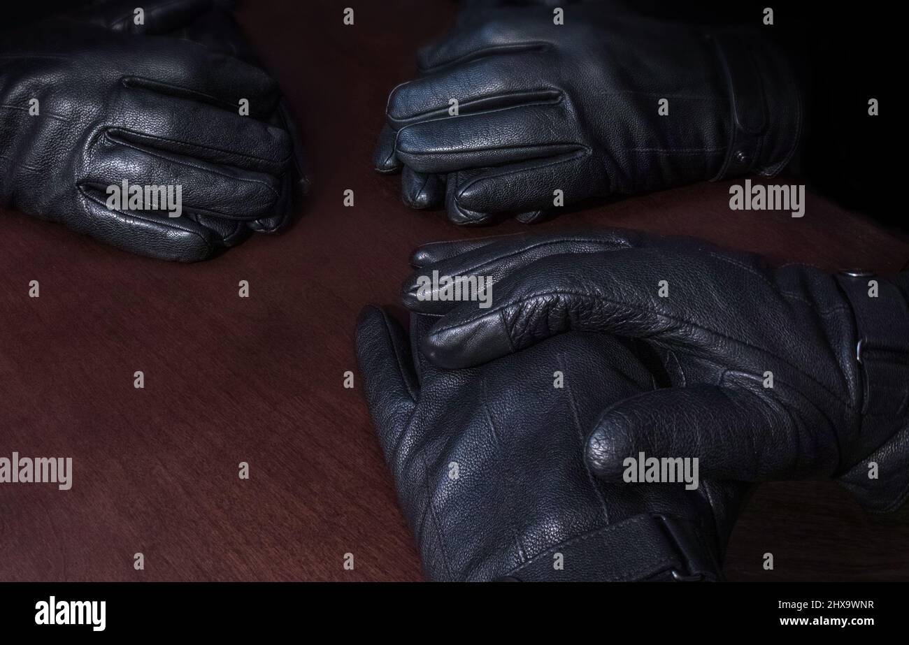 Three pairs of gloved hands, facing each other.. Stock Photo
