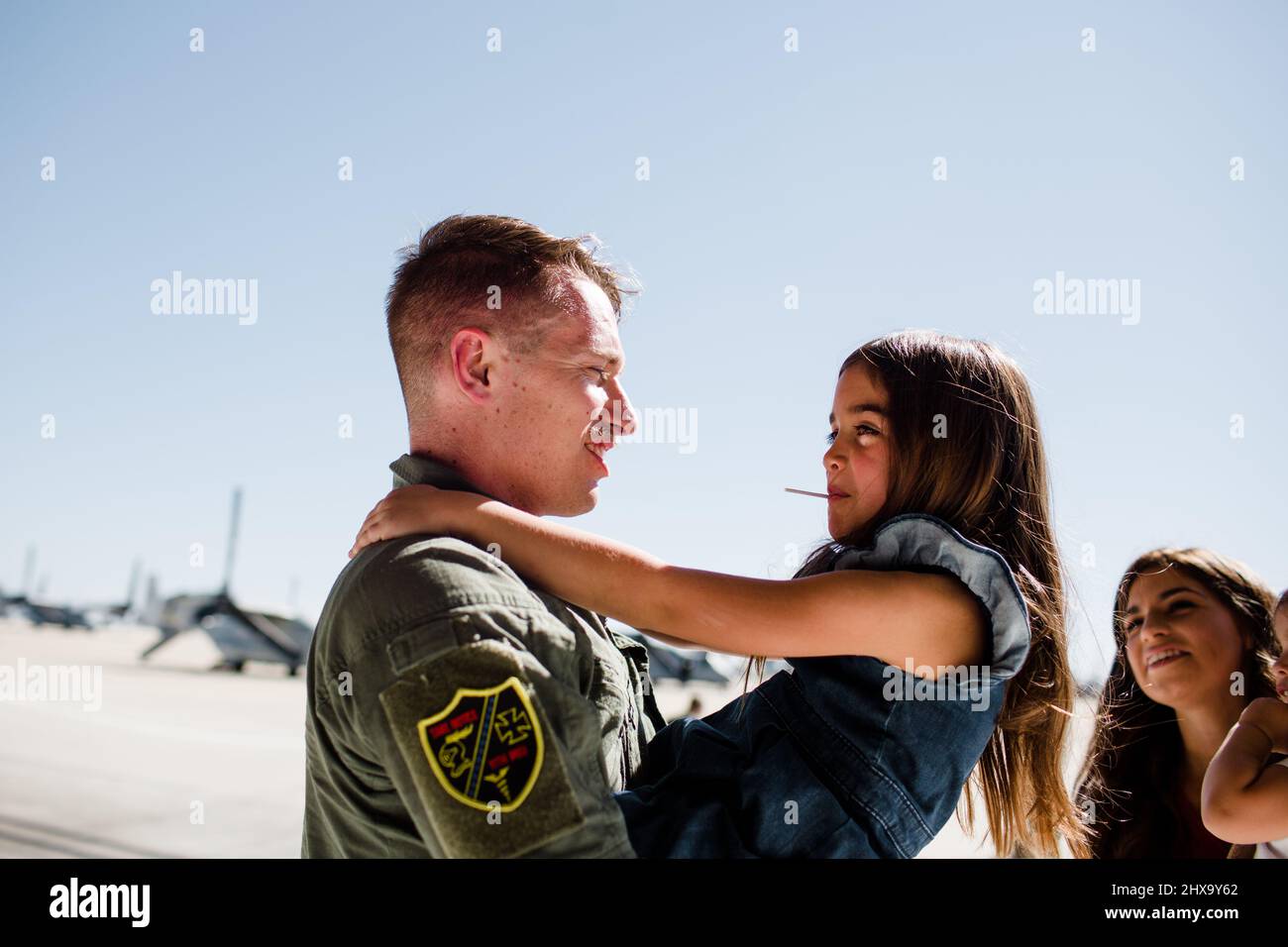 Dad Greeting Daughter After Returning from Deployment in San Diego Stock Photo