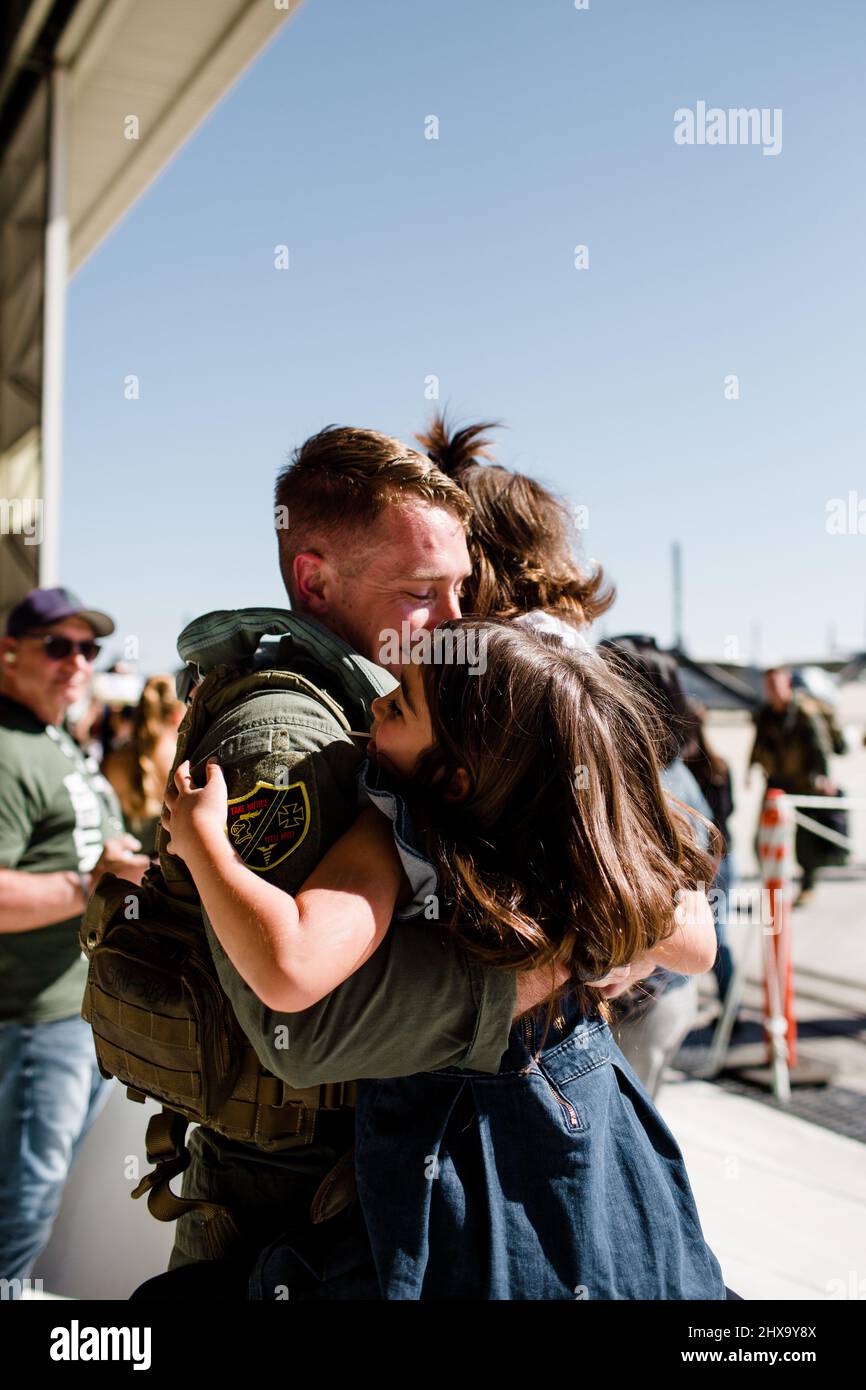Marine Hugging Daughters & Reuniting with Family in San Diego Stock Photo