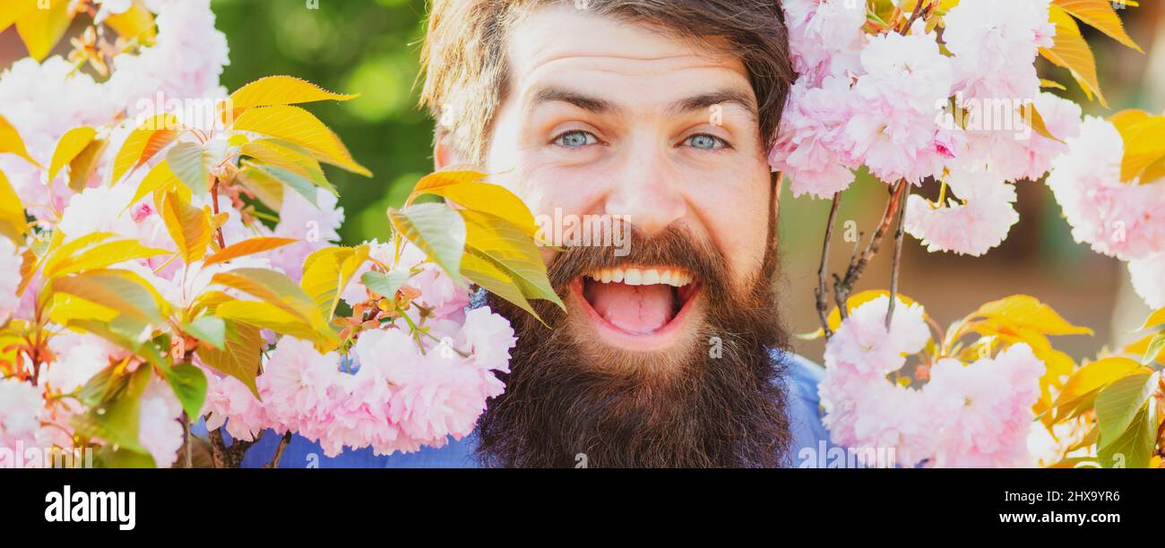 Person Outside Spring Spring banner of man outdoor. Outdoor partrait of young man surrounded ...