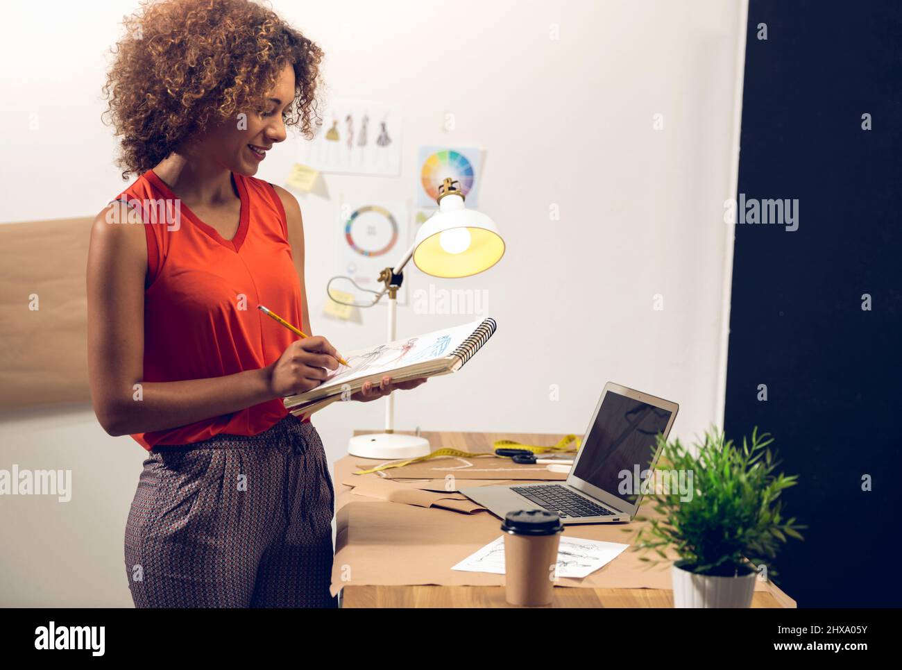 Fashion designer working on her atelier Stock Photo - Alamy