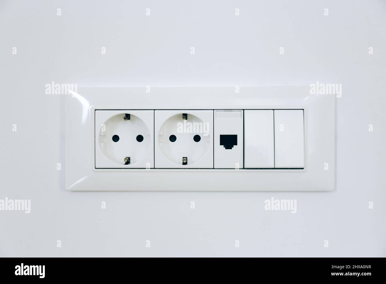 Electric light switch and socket on the white wall Stock Photo Alamy