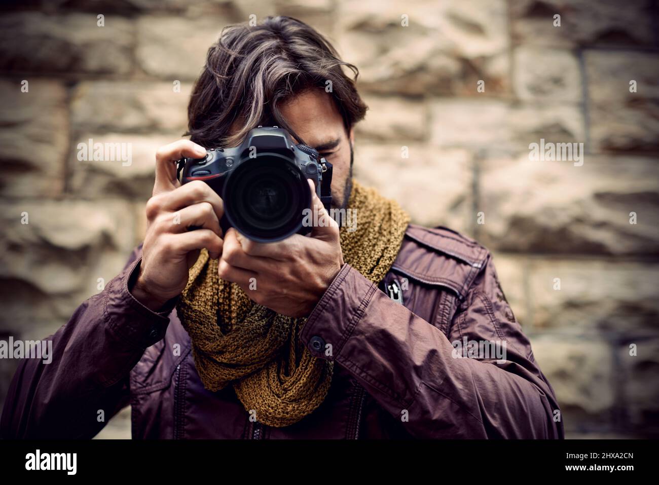Photography is my passion. Shot of a handsome young photographer at work in the city. Stock Photo