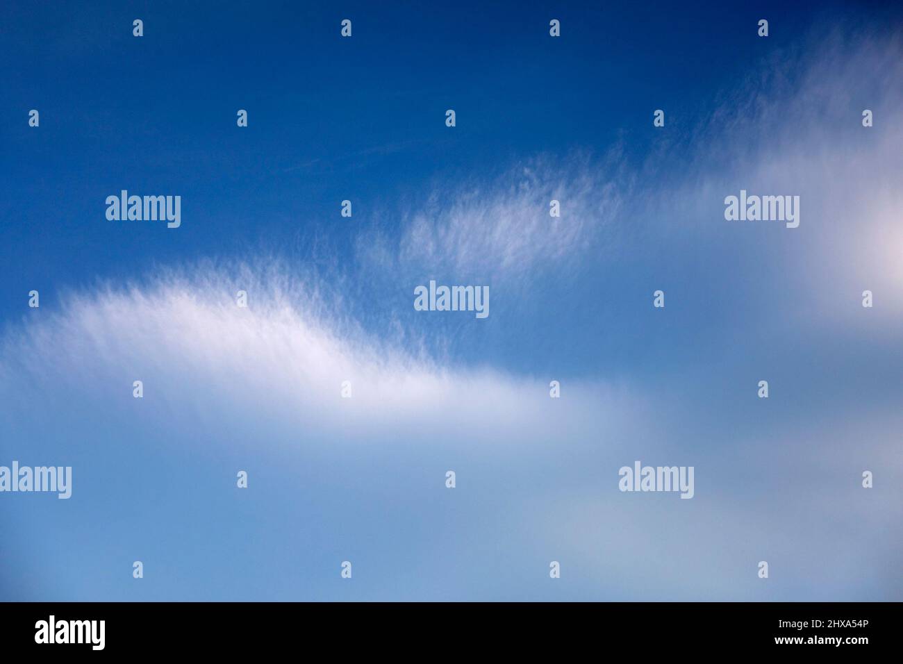 Fuzzy white cirrus cloud in blue sky Stock Photo