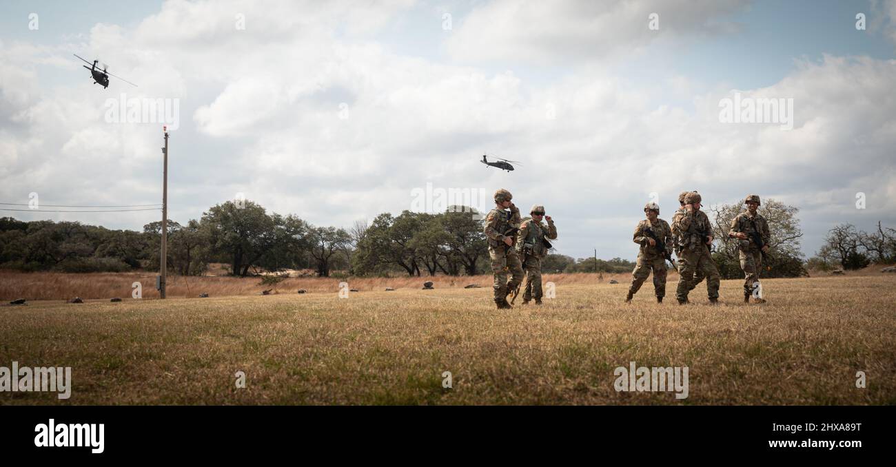 U.S. Army Reserve Soldiers unload from a UH-60 Black Hawk helicopter at the consortium best warrior competition from March 3 through the 6 at Camp Bullis in San Antonio, Texas. The 2022 consortium BWC consists of a 12-mile ruck march, weapon qualifications, the Army Combat Fitness Test, water survival, obstacle course, land navigation, and urban warfare. This competition was a joint event featuring Soldiers from the 80th Training Command, 807th Medical Command, 76th Operational Response Command, 63rd Readiness Division, 81st RD, 88th RD and the 99th RD. (U.S. Army Reserve photo by Spc. Kenneth Stock Photo