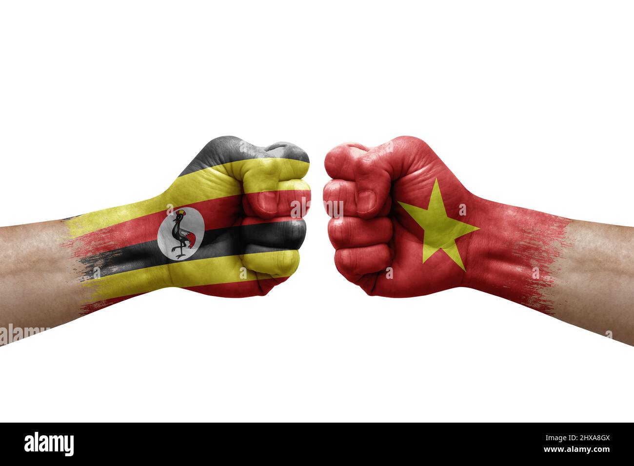 Two hands punch to each others on white background. Country flags painted fists, conflict crisis concept between uganda and vietnam Stock Photo