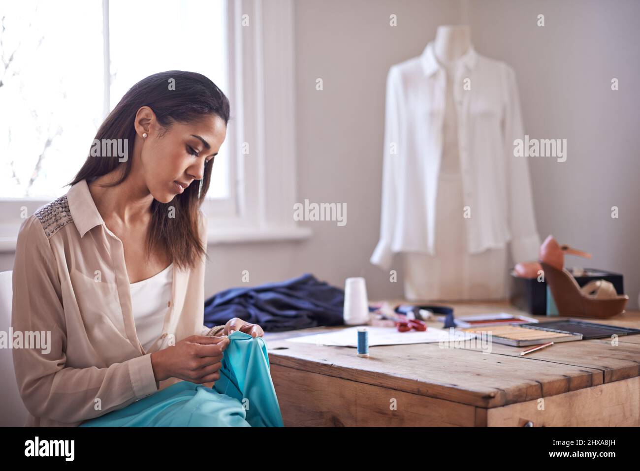 Fashion is a passion. Shot of a young fashion designer working on a new design. Stock Photo